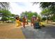 Colorful playground featuring slides, climbing structures, and a soft landing surface at 8341 W Gross Ave, Tolleson, AZ 85353