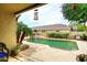 Beautiful pool area with lush landscaping, comfortable seating, and a serene atmosphere at 8341 W Gross Ave, Tolleson, AZ 85353
