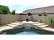 Pool with lounge chairs and a water feature offering a peaceful outdoor retreat at 8341 W Gross Ave, Tolleson, AZ 85353