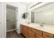 Bathroom featuring double sinks, wooden cabinets, vanity lighting, and a walk-in shower at 860 N Mcqueen Rd # 1157, Chandler, AZ 85225
