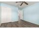 Bedroom with modern ceiling fan, closet with sliding doors, and light blue painted walls at 860 N Mcqueen Rd # 1157, Chandler, AZ 85225