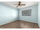 Bright bedroom with a ceiling fan, a window with blinds and light blue painted walls at 860 N Mcqueen Rd # 1157, Chandler, AZ 85225