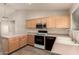 The kitchen features an efficient layout with wood cabinets and modern appliances at 860 N Mcqueen Rd # 1157, Chandler, AZ 85225