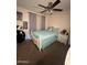 Cozy bedroom with a ceiling fan, decorative bedding, and a cute panda bear plush at 9060 N 47Th Ln, Glendale, AZ 85302