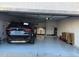 Clean garage featuring sealed concrete floors, laundry area, and ample storage space; car visible at 9060 N 47Th Ln, Glendale, AZ 85302