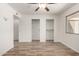 A bright bedroom with ceiling fan and large closets at 9863 W Country Club Ct, Sun City, AZ 85373