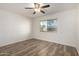 Bedroom features a ceiling fan and wood-look floors at 9863 W Country Club Ct, Sun City, AZ 85373