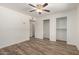 This bedroom includes wood-look floors, a ceiling fan, and spacious closets at 9863 W Country Club Ct, Sun City, AZ 85373