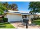 Well-maintained single-story home with a garage, tidy lawn, and welcoming curb appeal at 9863 W Country Club Ct, Sun City, AZ 85373