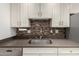 Close up of the Kitchen sink and backsplash at 9863 W Country Club Ct, Sun City, AZ 85373