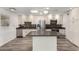 Updated kitchen featuring stainless steel appliances, white cabinets, and a center island at 9863 W Country Club Ct, Sun City, AZ 85373
