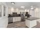 Bright kitchen features stainless steel appliances and white cabinets at 9863 W Country Club Ct, Sun City, AZ 85373