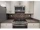 Close up of the Kitchen oven, stovetop, and microwave at 9863 W Country Club Ct, Sun City, AZ 85373