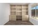 Comfortable office space featuring built-in shelving and a window for natural light at 9863 W Country Club Ct, Sun City, AZ 85373