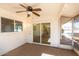 Covered patio with a ceiling fan and sliding glass doors to the interior at 9863 W Country Club Ct, Sun City, AZ 85373