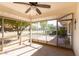 Enclosed patio with a ceiling fan and views of the landscaped backyard at 9863 W Country Club Ct, Sun City, AZ 85373