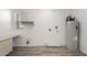 Utility room with updated flooring, water heater, and storage cabinet at 9863 W Country Club Ct, Sun City, AZ 85373