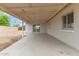 The covered back patio opens to the backyard through a sliding glass door at 9920 N 73Rd Ave, Peoria, AZ 85345
