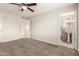 Comfortable bedroom with ceiling fan and access to an ensuite bathroom at 9920 N 73Rd Ave, Peoria, AZ 85345