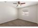 Neutral carpeted bedroom features a ceiling fan and natural light through a window at 9920 N 73Rd Ave, Peoria, AZ 85345