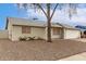 Close up shot of the exterior of a single-story home, featuring low maintenance landscaping at 9920 N 73Rd Ave, Peoria, AZ 85345