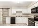 Well-lit kitchen features white cabinets, granite countertops, and a modern appliance package at 9920 N 73Rd Ave, Peoria, AZ 85345