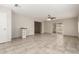 Open living room features tile flooring, ceiling fan, and sliding glass doors to the backyard at 9920 N 73Rd Ave, Peoria, AZ 85345