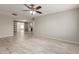 Bright living room featuring tile floors, with views to a kitchen and barn doors at 9920 N 73Rd Ave, Peoria, AZ 85345