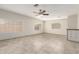 Well-lit living room with tile floors, ceiling fan, and plenty of natural light at 9920 N 73Rd Ave, Peoria, AZ 85345