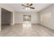Bright living room with tile flooring, neutral walls, and ceiling fan for comfortable living at 9920 N 73Rd Ave, Peoria, AZ 85345