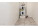 Utility room with a water heater and ceramic tile flooring at 9920 N 73Rd Ave, Peoria, AZ 85345
