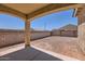 This home features a large dirt backyard with a block wall and covered patio at 10837 W Bloch Rd, Tolleson, AZ 85353