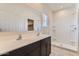 Bathroom featuring double sink vanity, large mirror, and a walk-in shower at 10837 W Bloch Rd, Tolleson, AZ 85353