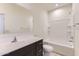 This bathroom features a shower-tub combo, and a sink vanity with dark wood cabinets at 10837 W Bloch Rd, Tolleson, AZ 85353