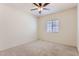 Inviting bedroom with carpet, a ceiling fan, and a window with natural light at 10837 W Bloch Rd, Tolleson, AZ 85353