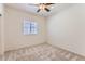 This cozy bedroom features neutral paint and carpet and a ceiling fan at 10837 W Bloch Rd, Tolleson, AZ 85353