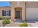 Close-up of the front entrance, highlighting the covered porch, stylish door, and desert landscaping at 10837 W Bloch Rd, Tolleson, AZ 85353
