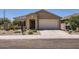 Inviting single-story house with a two-car garage, desert landscaping, and a welcoming entryway at 10837 W Bloch Rd, Tolleson, AZ 85353
