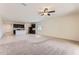 Open-concept living area with a ceiling fan, seamless transition to kitchen with a breakfast bar at 10837 W Bloch Rd, Tolleson, AZ 85353