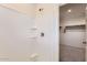 New shower featuring bright, clean tiles, built in shelving, and modern fixtures at 10837 W Bloch Rd, Tolleson, AZ 85353