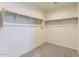 Walk-in closet with carpet, built-in shelving, and ample storage space at 10837 W Bloch Rd, Tolleson, AZ 85353