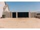 Property featuring a block wall and black metal gate at the edge of a sand lot. Mountains are visible in the background at 1228 N 106Th Pl, Mesa, AZ 85207
