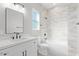 Bright bathroom featuring a white vanity with marble countertop and a tiled shower and tub combo at 1228 N 106Th Pl, Mesa, AZ 85207