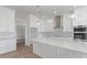 New kitchen features white cabinets, quartz countertops, and stainless steel appliances at 1228 N 106Th Pl, Mesa, AZ 85207