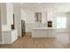 Bright, open kitchen with stainless steel appliances, white cabinets, a large island, and stylish pendant lighting at 1228 N 106Th Pl, Mesa, AZ 85207