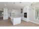 Modern kitchen featuring white cabinets, a large island, and stainless steel appliances at 1228 N 106Th Pl, Mesa, AZ 85207