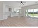 Bright and spacious living area with wood-look flooring, flowing into a modern kitchen at 1228 N 106Th Pl, Mesa, AZ 85207