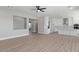 Open-concept living area with wood-look floors, seamlessly connecting living and kitchen spaces at 1228 N 106Th Pl, Mesa, AZ 85207