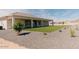 Beautiful backyard featuring a covered patio, artificial grass, and mature landscaping at 1229 N 106Th Pl, Mesa, AZ 85207