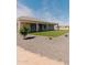 Spacious backyard with a covered patio and well-manicured artificial grass, perfect for outdoor entertaining at 1229 N 106Th Pl, Mesa, AZ 85207